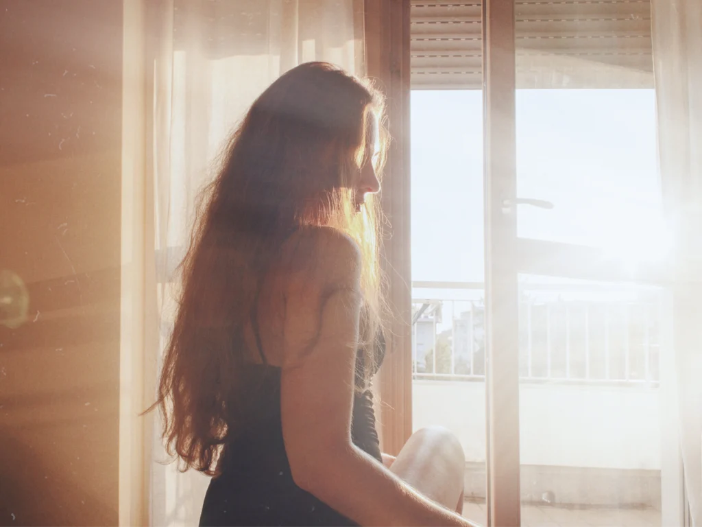 Trafficking survivor stepping through an open doorway toward freedom and legal protection under the T visa