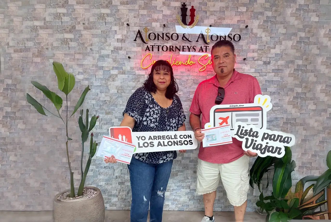 couple celebrating getting their visas with Vanessa Alonso