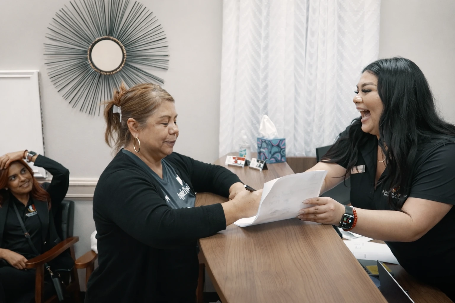 Immigration lawyer assisting client with paperwork in McAllen law office