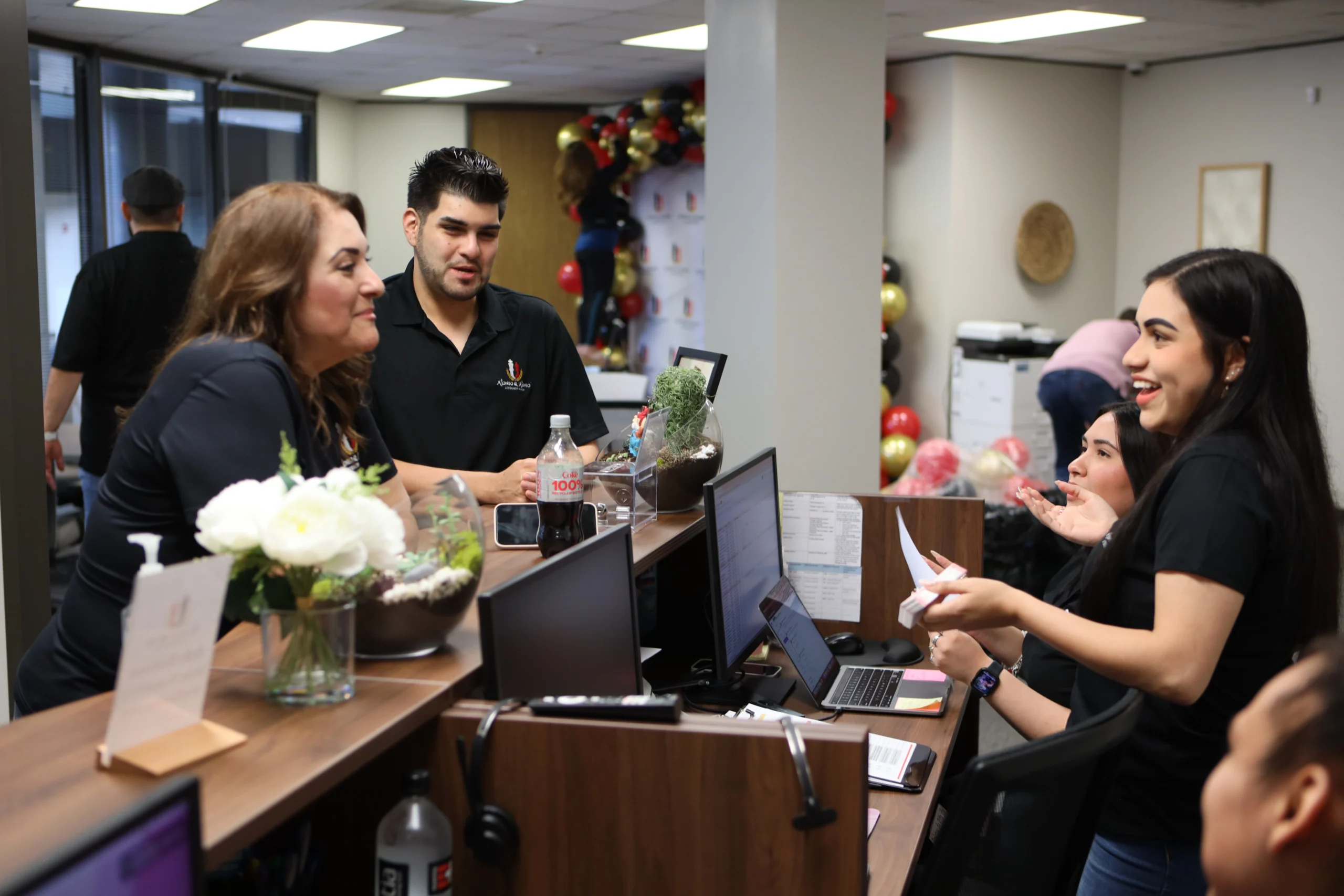 Houston immigration law firm team assisting clients at the office with residency, citizenship, and immigration legal services.